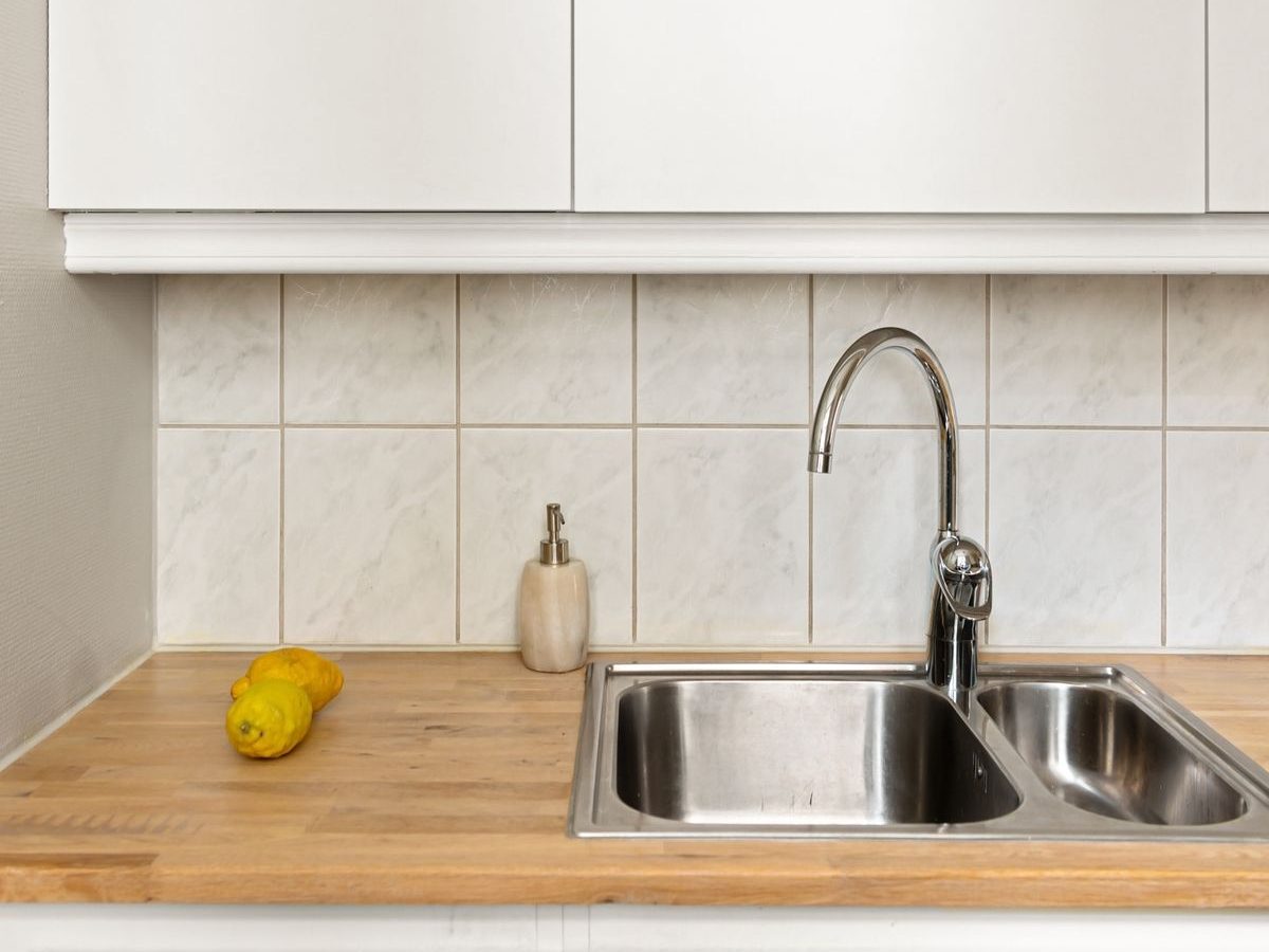 Compact bar and prep faucet at a secondary kitchen sink